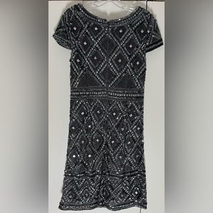 Fitting, but very elegant dress. Hem hits at the knee.